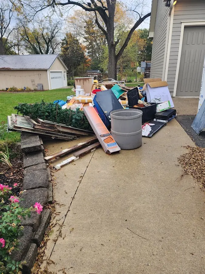 Dumpster being loaded with debris for Commercial Dumpster Rental in Claryville